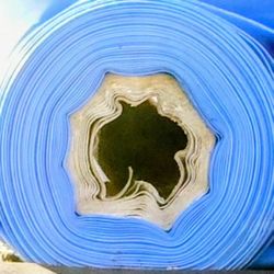 Large roll of new multi-use plastic tarp.