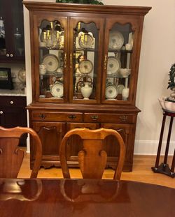 Elegant wooden china cabinet and dining table set