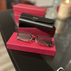 l:I Cartier black frame sunglasses with grey lens 