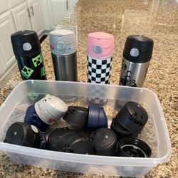 Four Water Bottles And Extra Tops 