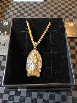 10 karat gold yellow and white gold Virgin Mary medallion on a 10 karat gold rope chain 22" lobster clamp