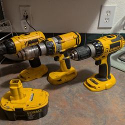 Three 18-volt dewalt power drills and one 18-volt battery