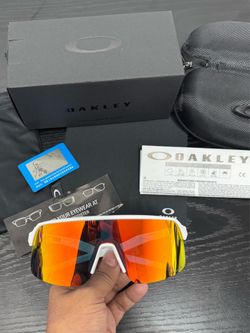 in a white/matte white frame with Prizm orange/gradient lenses