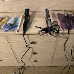 A Bag Of Combs And Straighteners And Curel Irons