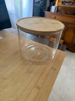 Glass storage container with wood lid and seal