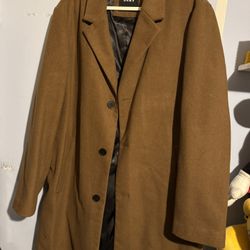 This is a DKNY wool blend notch collar coat in a camel/brown color