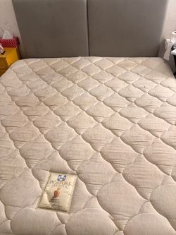California King mattress with a box spring and headboard