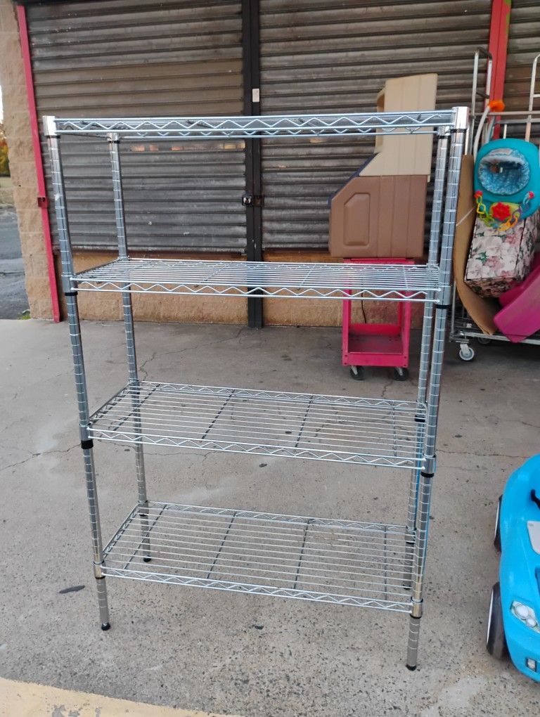 chrome wire shelving unit. These types of shelving units are commonly used for storage in garages, kitchens, and commercial spaces. 3x14x55"H