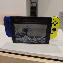 1st Gen Nintendo Switch with neon and purple controllers