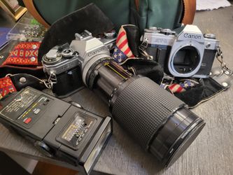 Canon AE-1 And  AT-1 Camera With Lenses