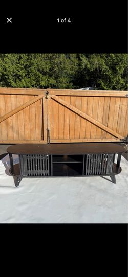 Modern Black Oval TV Stand with Sliding Slatted Doors