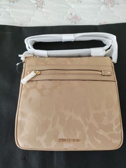 Michael Kors cross body. Never used . Still has tags, packing inside and on strap