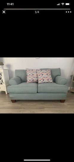 Teal couch with pillows