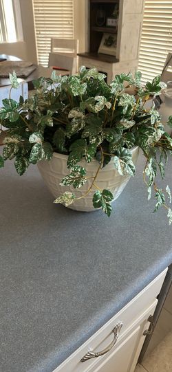 Plastic planter with artificial plant