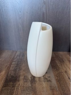 Elegant white vase with a sleek design.