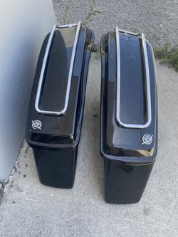 pair of Vivid Black Harley-Davidson hard saddlebags with chrome luggage racks.