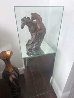 Glass enclosed cabinet with horse sculpture