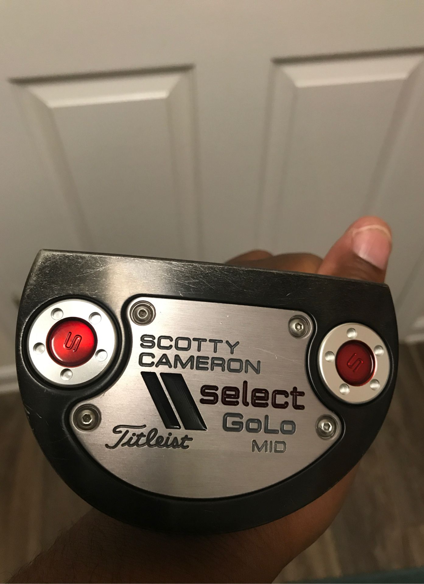 Scotty Cameron putter with adjustable tool and additional weights