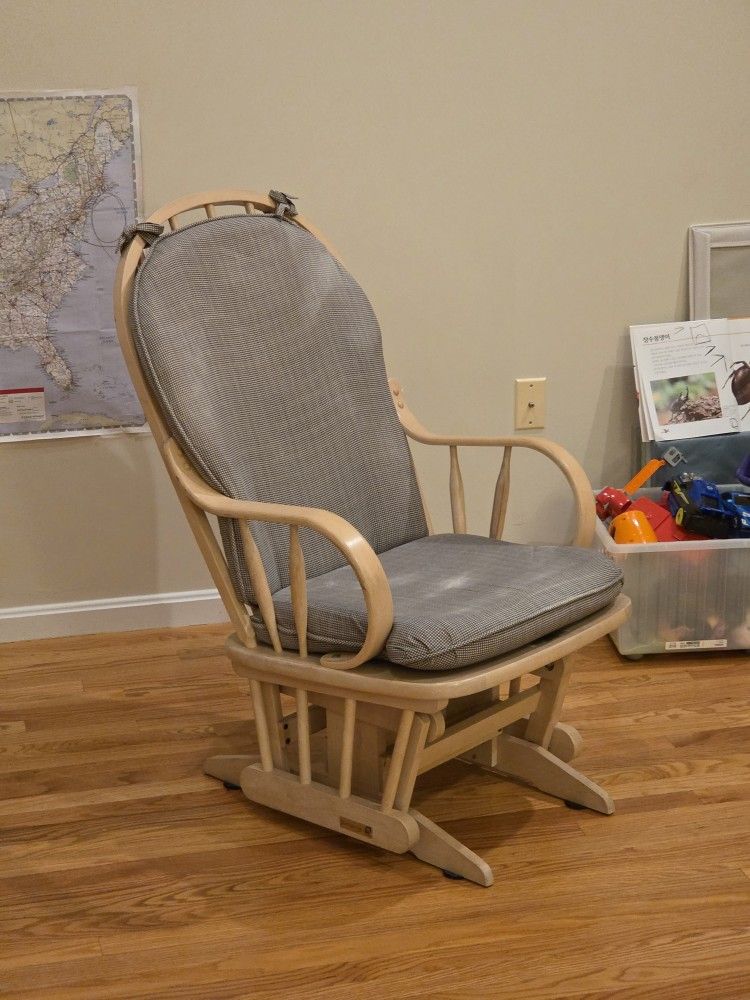 Slider rocking chair with grey cushions