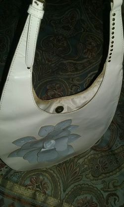 White leather purse with the blue flower