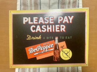 Retro metal sign with Dr. Pepper branding.