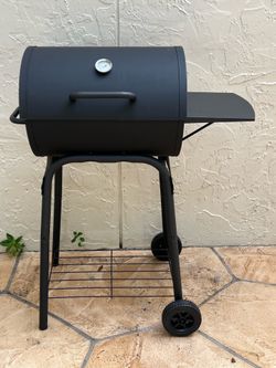Charcoal barrel grill with side shelf