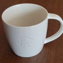 Starbucks Embossed Siren Logo White V handle Venti Coffee Mug 2010 20oz. 
Perfect shape, no chips or crack. It is 4 1/3" tall, weight 1lb 2oz plus 
sh
