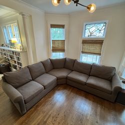Large, three-piece sectional sofa with angled wedge. Textured brown fabric..