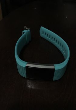 Turquoise FitBit charge 2 with charger