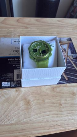 The Lacoste LC33 is a 45mm men's analog-digital watch featuring a transparent green silicone strap and a matching textured dial