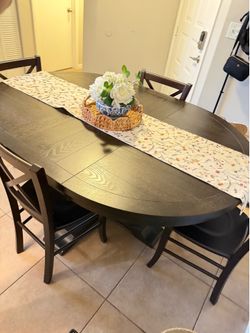 Dark wood dining table with extendable leaf