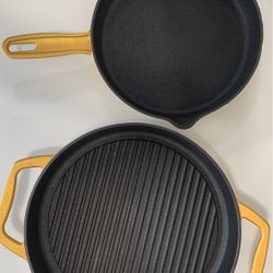 Two gold cast-iron pans
