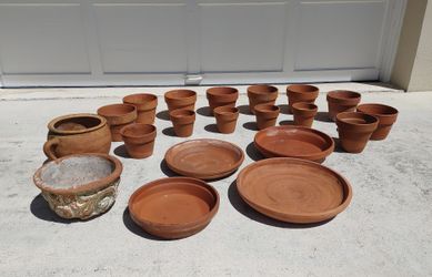 Preowned bunch of clay flower pots and saucers