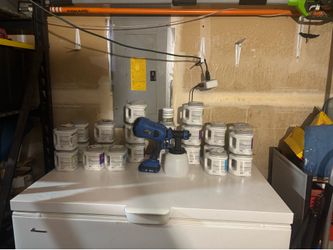 Sample latex paint and a new paint sprayer gun