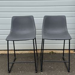 Two counter height gray chairs