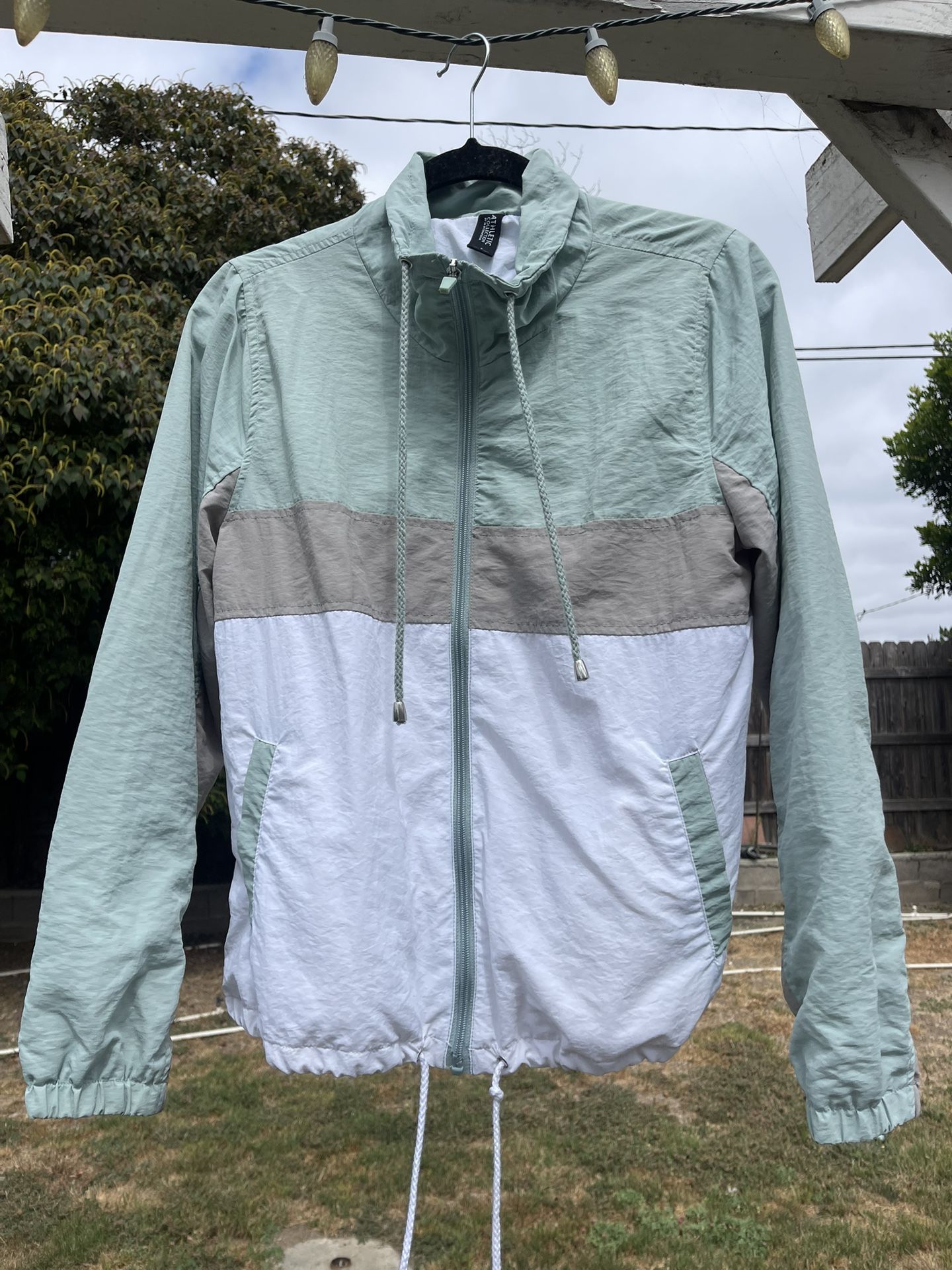 Green and white windbreaker jacket with drawstring