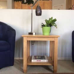 Mission-style oak end table featuring open slat sides and a lower shelf