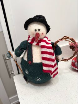 Snowman figurine holding a shovel and wreath-12 inches