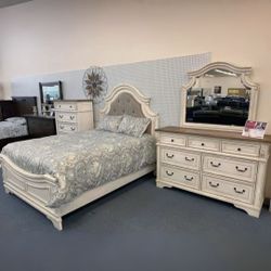 Realyn Chipped White Upholstered Panel Bedroom Set