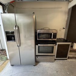 Stainless Steel Frigidaire Refrigerator/Freezer, Electric Range, Matching Microwave Vent, Wine Cooler
