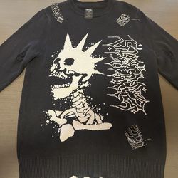 suéter negro deshilachado con diseño punk de la marca SWIXXZ. Size XS
