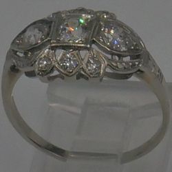 14KT WHITE GOLD ANTIQUE RING SIZE 7.5 2.3 GRAMS 1 CARAT  OF DIAMONDS STUNNING  PRE OWNED. STUNNING . ANTIQUE WITH APPROXIMATELY 3 DIAMONDS 0.25PTS ; 2