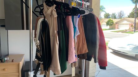 Beautiful young ladies belts, blouses, an slacks, and jackets.