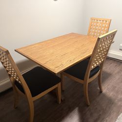Natural wood dining set includes 3 chairs.