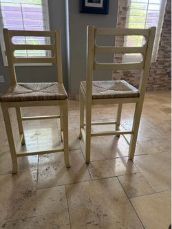 Two counter stools with seagrass seats