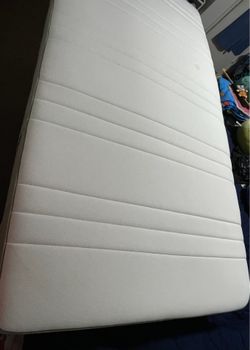 Twin mattress. White. Used but like new; it has a small stain.