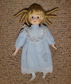 VINTAGE PORCELAIN DOLL WITH BLONDE HAIR CURLS 