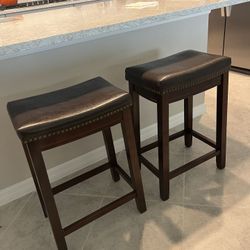 Two Dark Brown Saddle Chairs - Counter Height. (24inches)