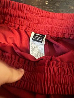Red pants with white stripes on the side