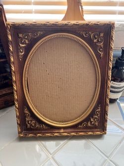 Vintage ornate wooden frame with no glass pane